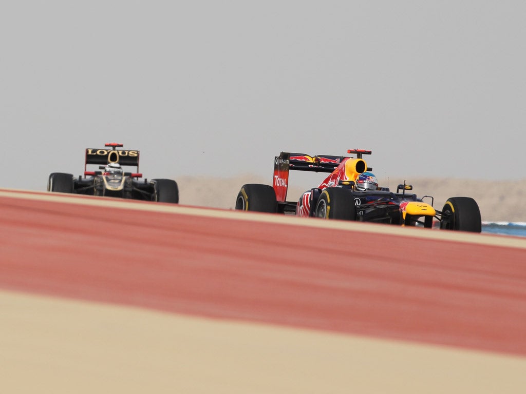 Lotus’s Kimi Raikkonen (left) and Red Bull’s Sebastian Vettel (right) fight it out, but it was the latter who took first place