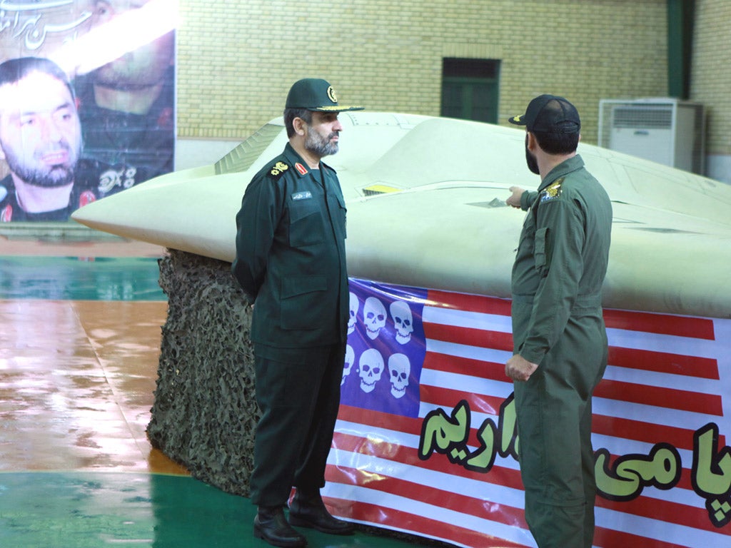 General Amir Ali Hajizadeh, left, with the US RQ-170 Sentinel drone