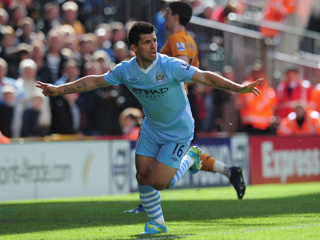 <b>Wolves 0-2 Man City</b><br/>
Sergio Aguero celebrates after opening the scoring for Man City in the 27th minute. A superb pass from Gael Clichy played the Argentine forward in before he coolly slotted the ball past Dorus de Vries in the Wolves goal.
