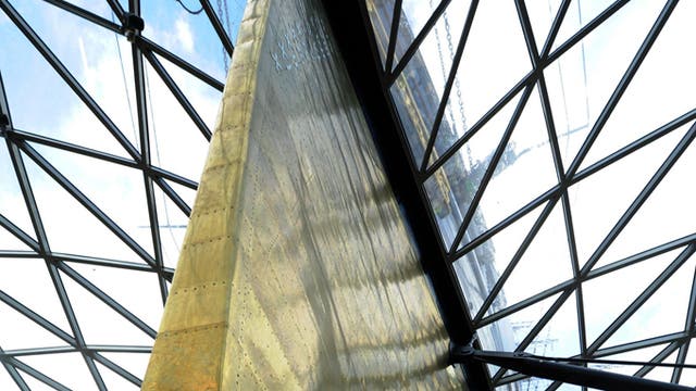 Conservators work in the dry berth under the Cutty Sark in Greenwich, London, as they apply the finishing touches to a display of over 80 figureheads.