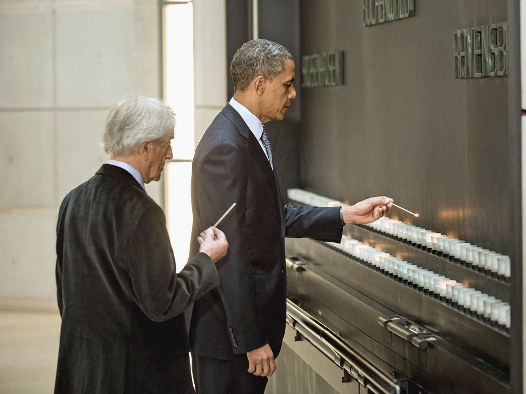 Elie Wiesel, Holocaust survivor and Founding Chairman of the United States Holocaust Memorial Council, lights a candle with Barack Obama at the United States Holocaust Memorial Museum
