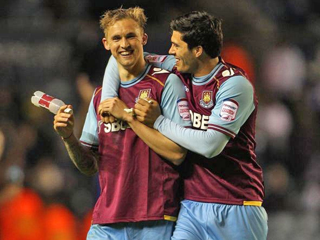 West Ham’s James Tomkins (right) celebrates with
winning goalscorer Jack Collison