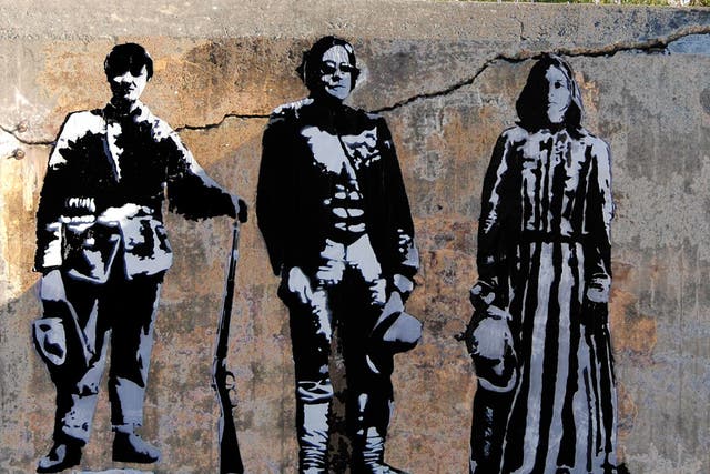 Blek le Rat depicts himself (centre) in one of his street stencils
