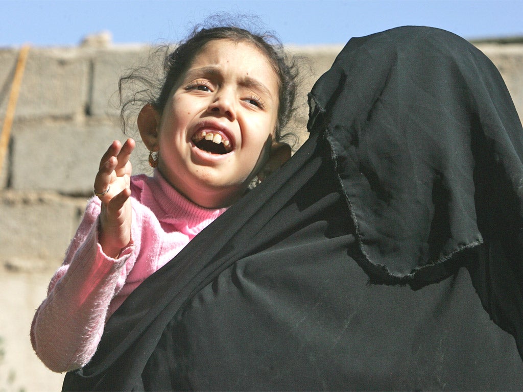 Mariam Yasir, six, with her mother in Fallujah - she suffers from a birth defect
