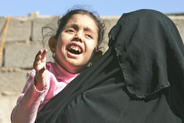 Mariam Yasir, six, with her mother in Fallujah - she suffers from a birth defect