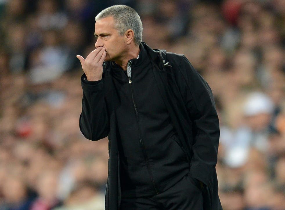 Jose Mourinho shields his mouth while handing out orders