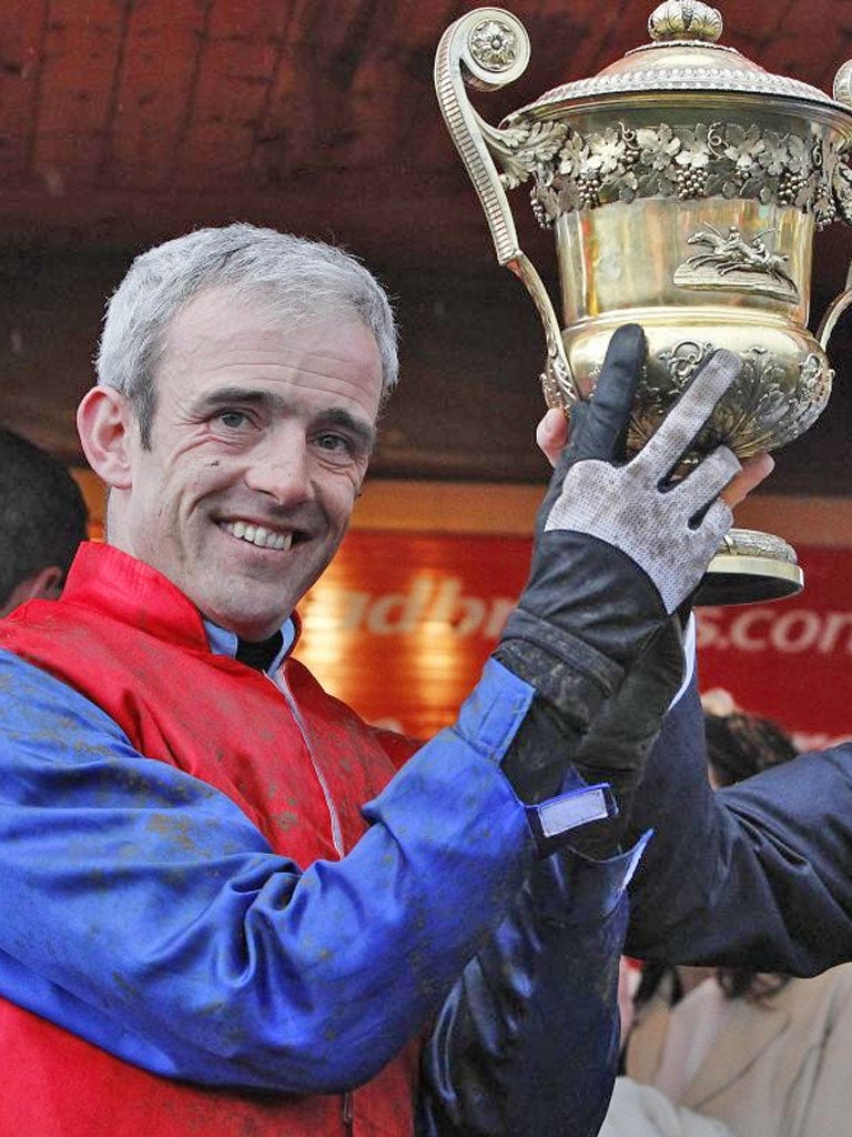 Ruby Walsh lifts the trophy after his World Series Hurdle win on Quevega