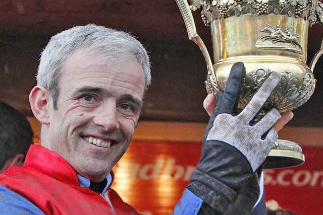 Ruby Walsh lifts the trophy after his World Series Hurdle win on Quevega