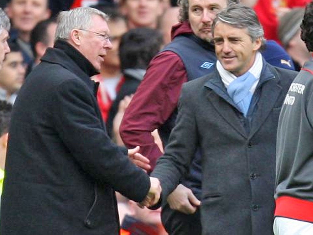 United's Alex Ferguson and City's Roberto Mancini shake hands