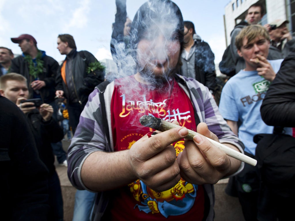 Protesters smoke marijuana during a demonstration against new government legislation calling for the creation of a 'weed pass' and the stopping of the substance's sale to foreigners, in Amsterdam last week.