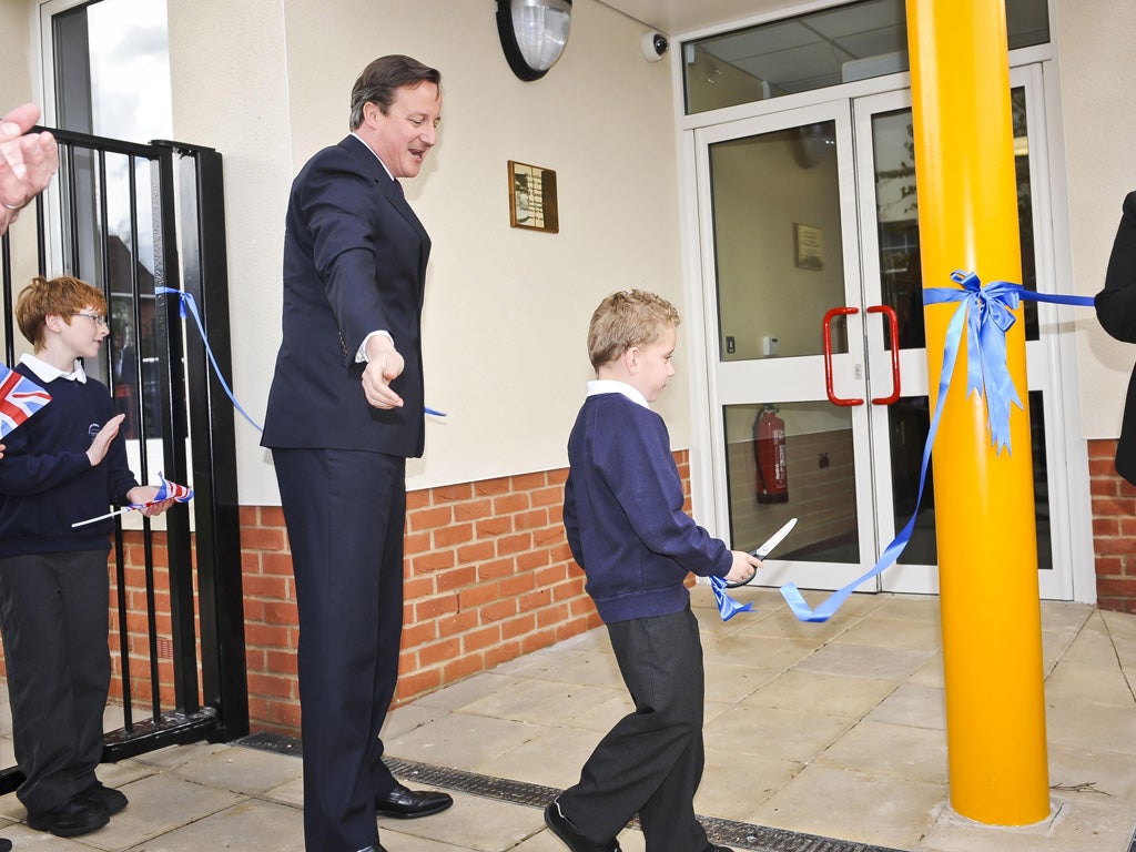 A school boy cuts the ribbon at this newly refurbished school