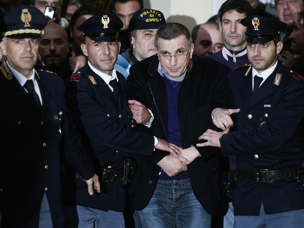 Policemen escort Michele Zagaria (centre), the boss of the Casalesi clan