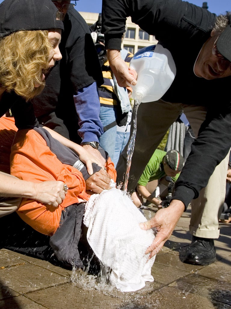 Protesters demonstrate the waterboarding technique on volunteer
Maboud Ebrahim Zadeh in Washington