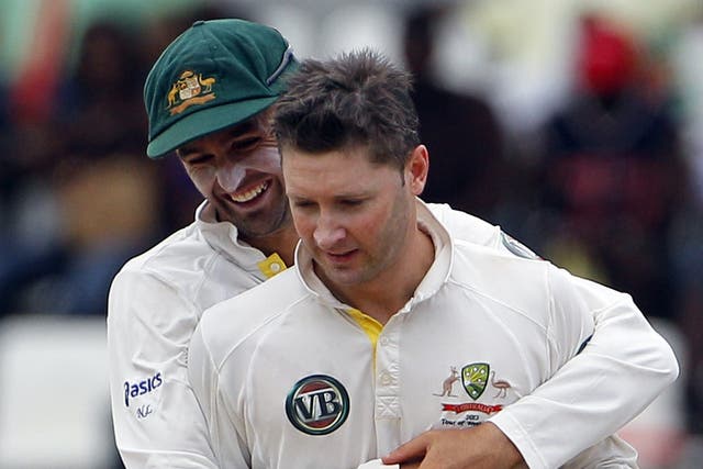 Australia's Michael Clarke (right) is hugged by team-mate Nathan
Lyon after taking the wicket of tailender Ravi Rampaul for 11