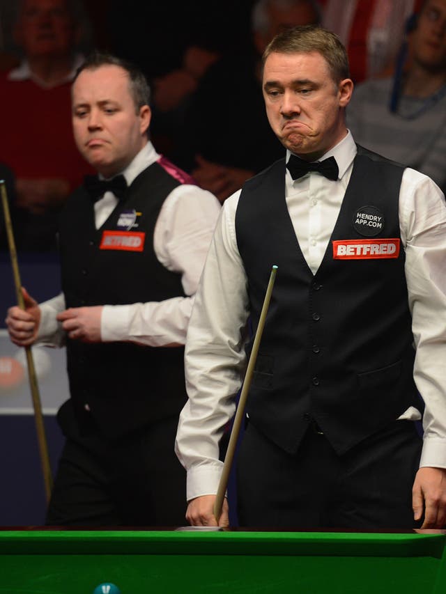 Stephen Hendry (right) deliberates over a shot as John Higgins looks on