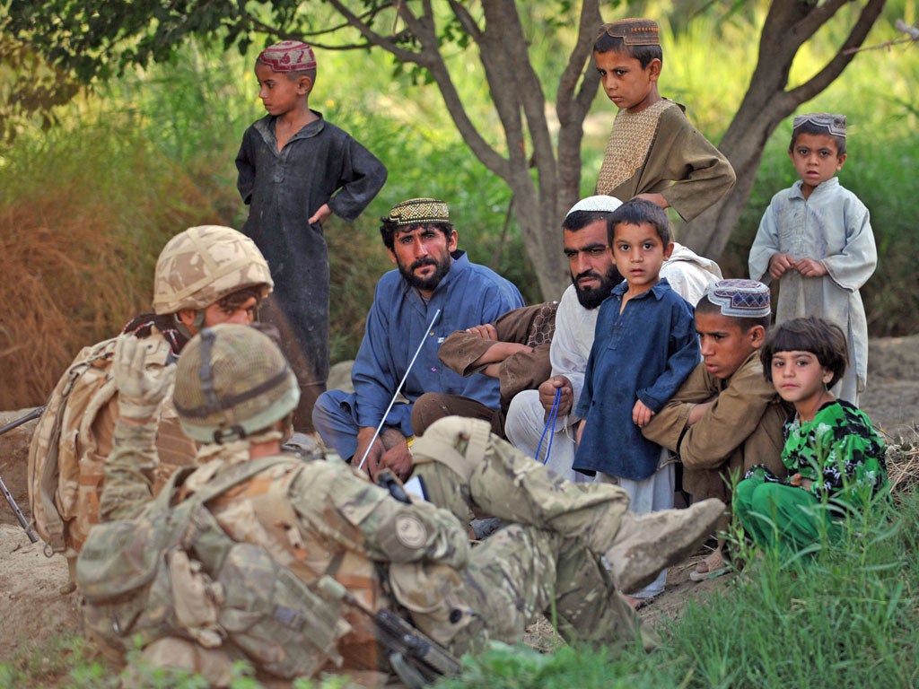 British soldiers with Afghan locals during a patrol in 2010