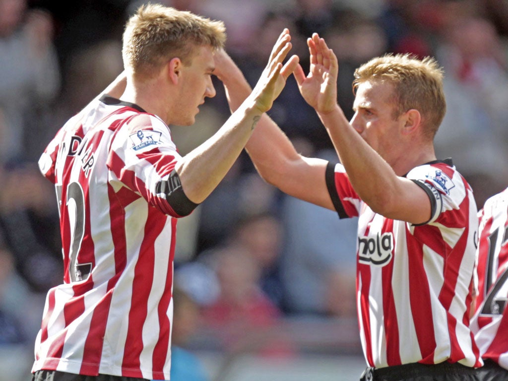 Light fantastic: Sunderland scorer Nicklas Bendtner (left) with Lee Cattermole