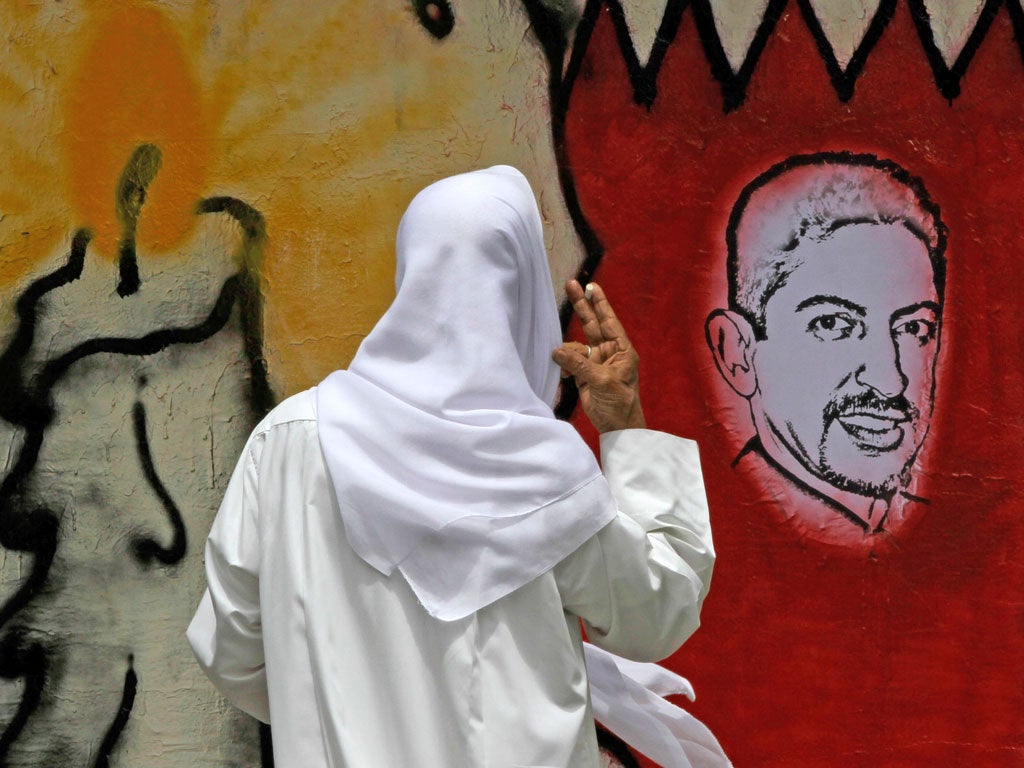 Protesters demand the release of Abdulhadi al-Khawaja, pictured on a street drawing