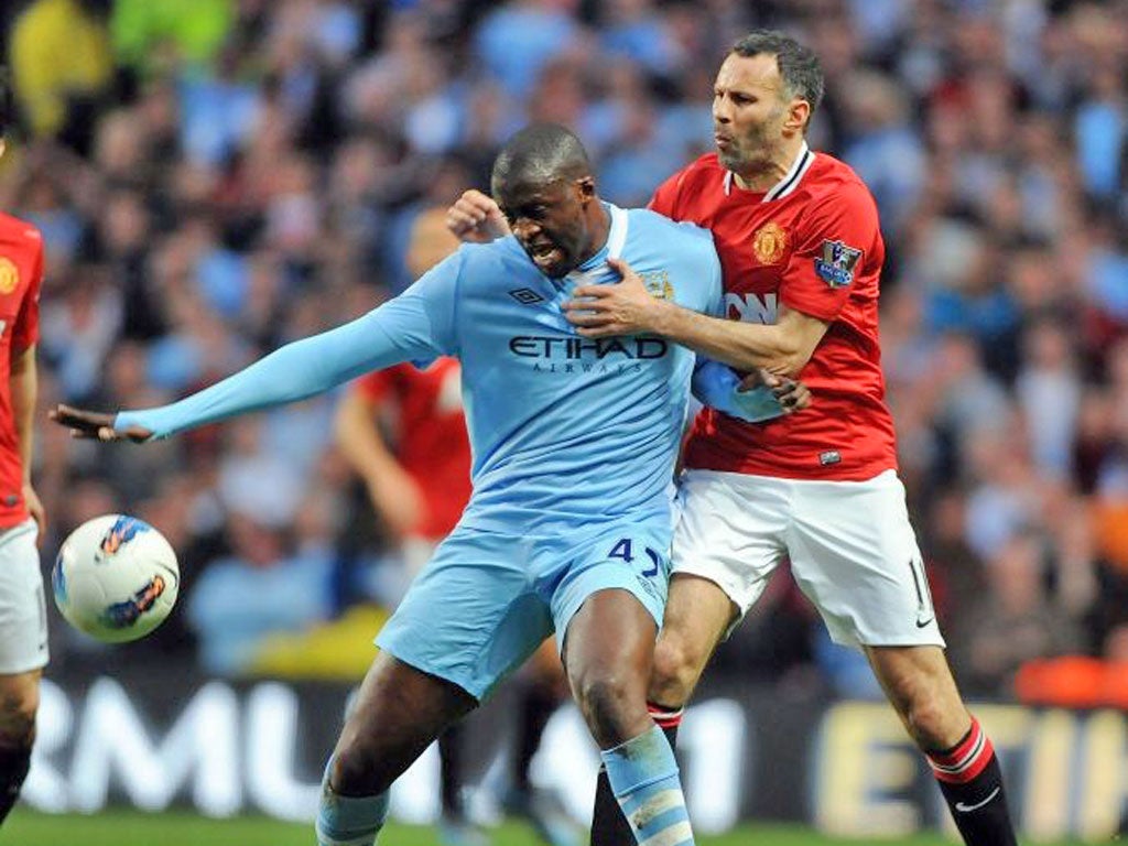 Ryan Giggs tries to get to grips with Yaya Touré