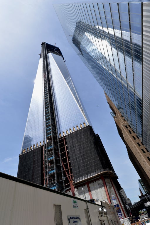 One World Trade Center (L) stands in New York City April 30, 2012. New York's skyline got a new king after the still unfinished World Trade Center tower, built to replace the destroyed Twin Towers, crept above the venerable Empire State Building.