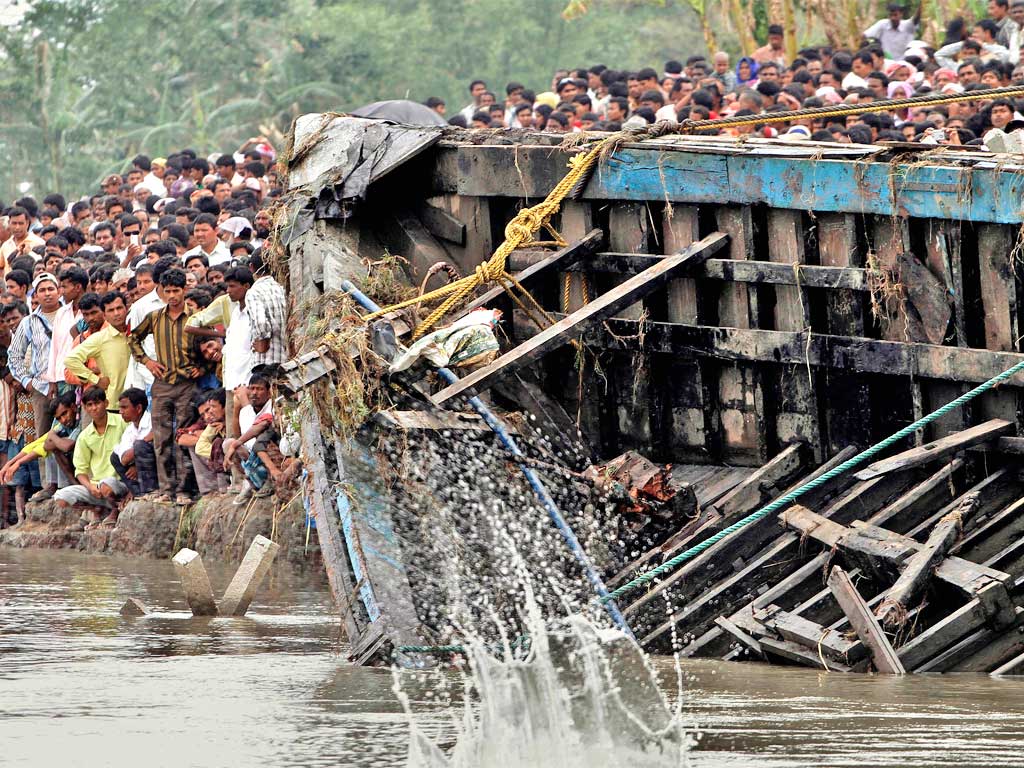 Rescuers pull out the wreckage of the capsized ferry yesterday from the Brahmaputra River near the remote north-east village of Buraburi
