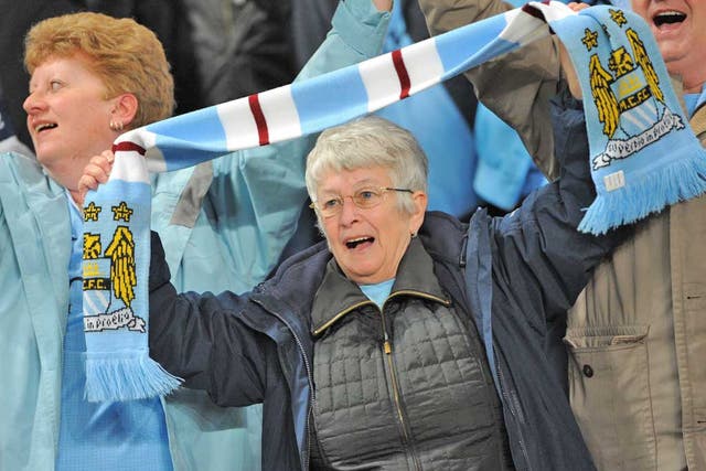 Manchester City fans cheer on their team during Monday's big game