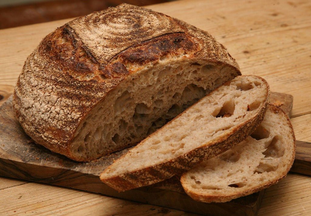 A golden-domed loaf of sourdough bread