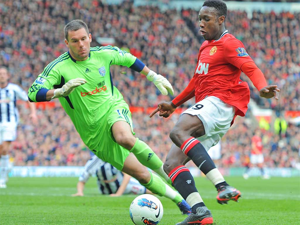 Ben Foster vies for the ball with Danny Welbeck at Old Trafford