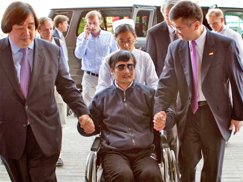 Chen Guangcheng (centre) can apply to study abroad, China's Foreign Ministry said today