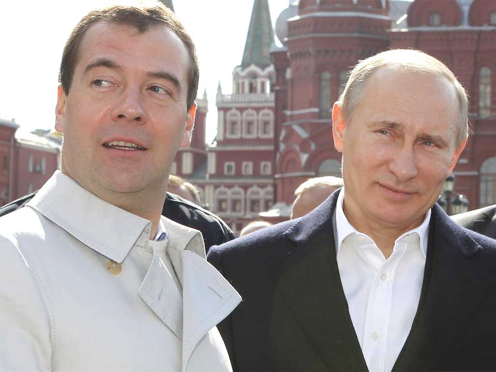 Dmitry Medvedev with Vladimir Putin on May Day in the much-maligned white jacket