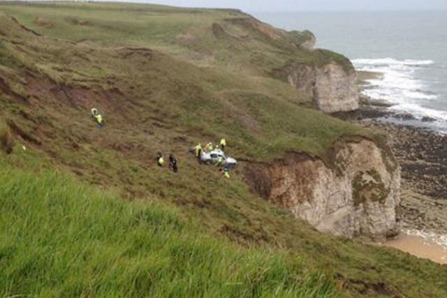 Emergency services rushed to the scene at Flamborough, East Yorkshire, as the BMW stopped 'precariously close' to a 100ft (30m) drop