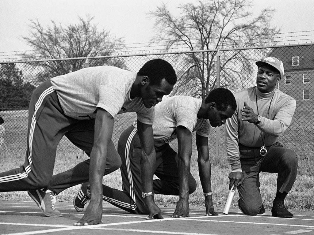 Walker, right, puts two Kenyan athletes through their paces in 1972