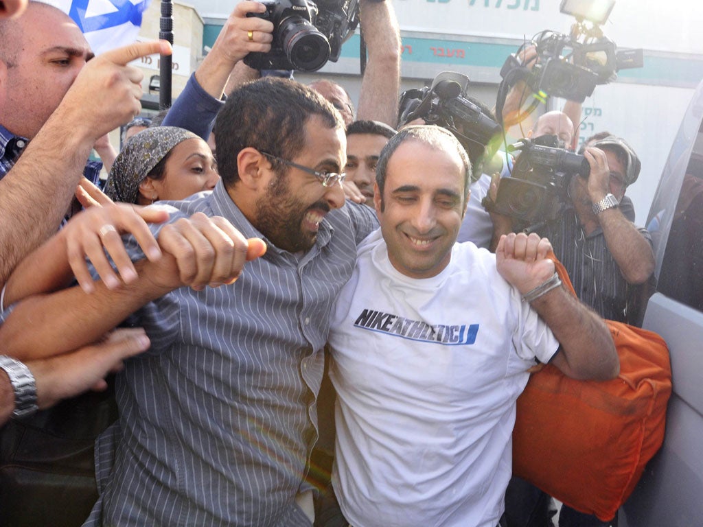 Hagai Amir, right, greets his supporters yesterday after being released from prison