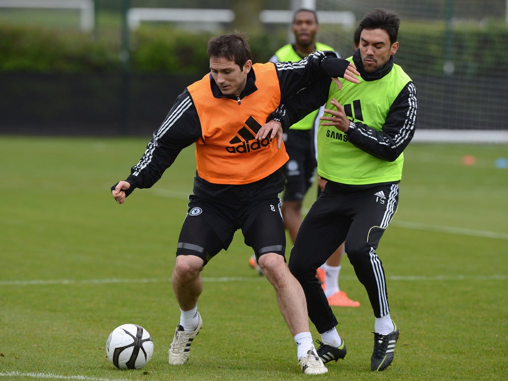 Frank Lampard holds off Paulo Ferreira during a training session
at Cobham yesterday