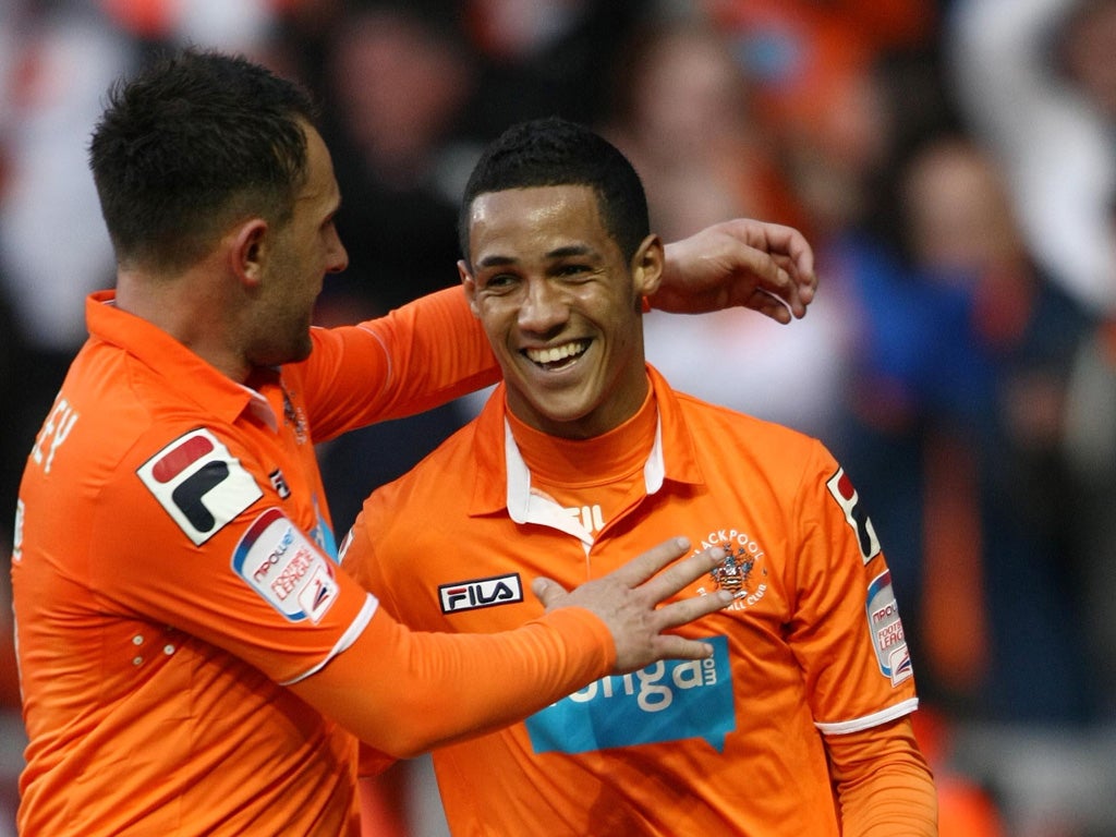 Tom Ince (right) celebrates after his shot was deflected in by Curtis Davies for Blackpool's winner last night