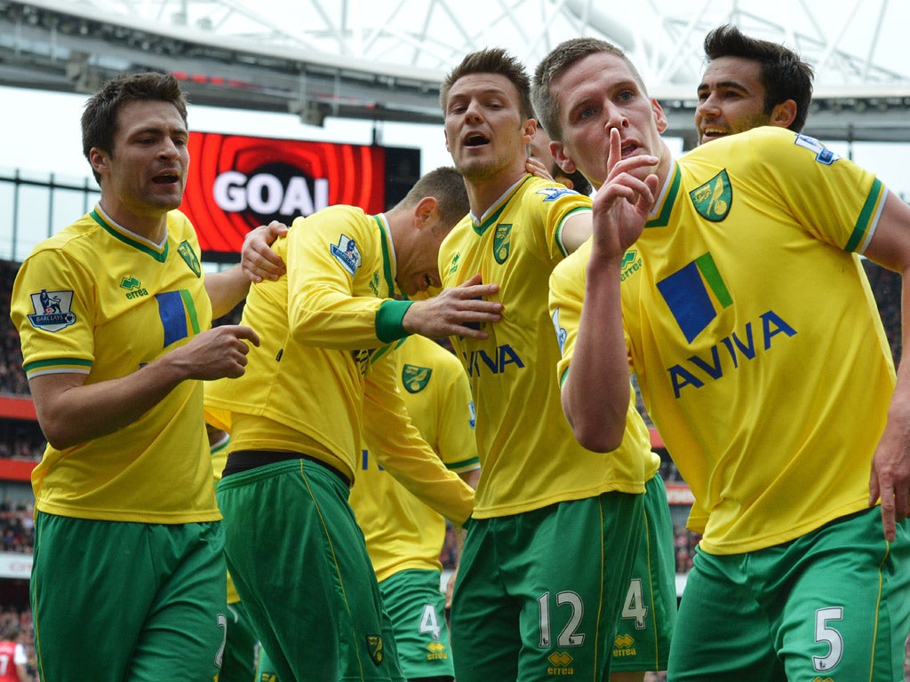 Steve Morison, celebrates with team-mates after scoring Norwich's third goal