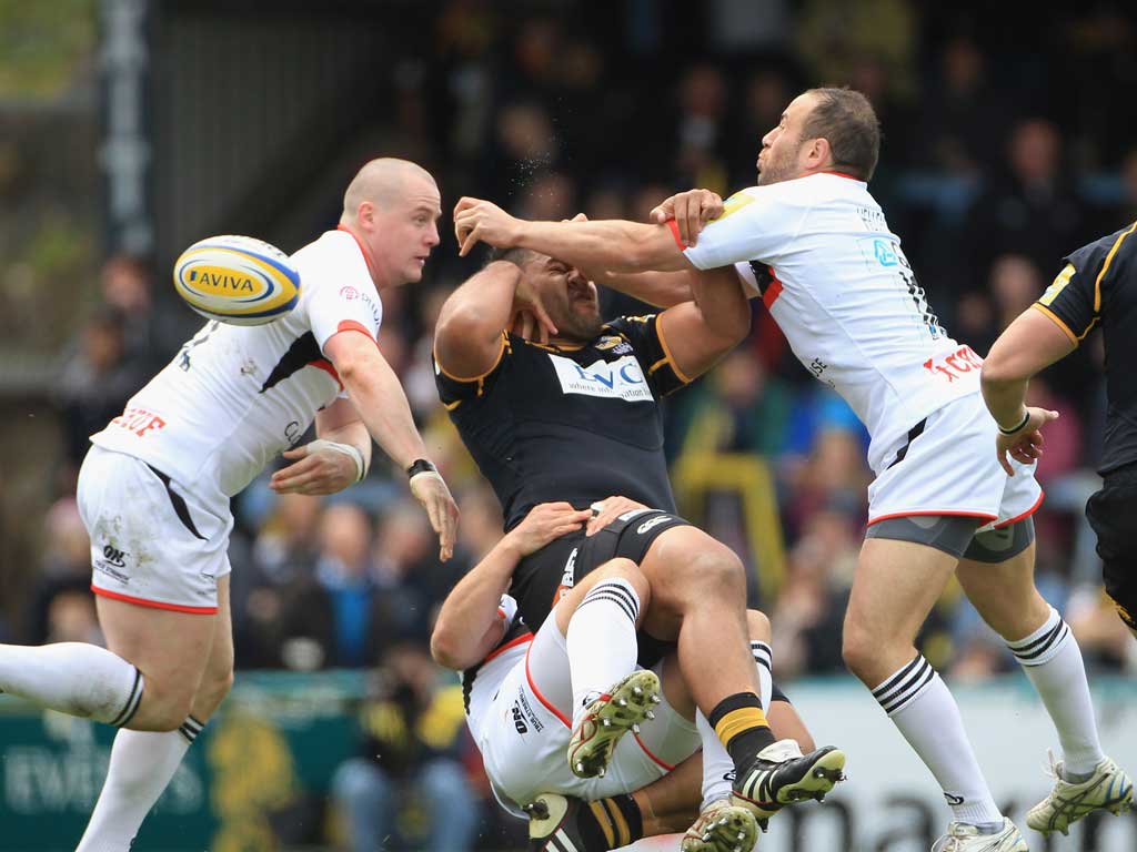 Wasp swatted: No 8 Billy Vunipola feels the full force of the Newcastle Falcons defence at Adams Park