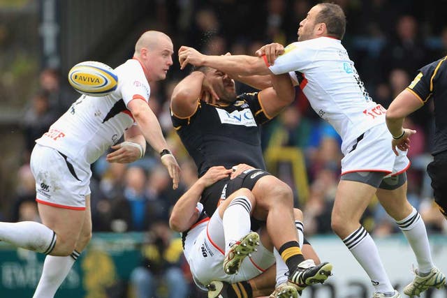 Wasp swatted: No 8 Billy Vunipola feels the full force of the Newcastle Falcons defence at Adams Park