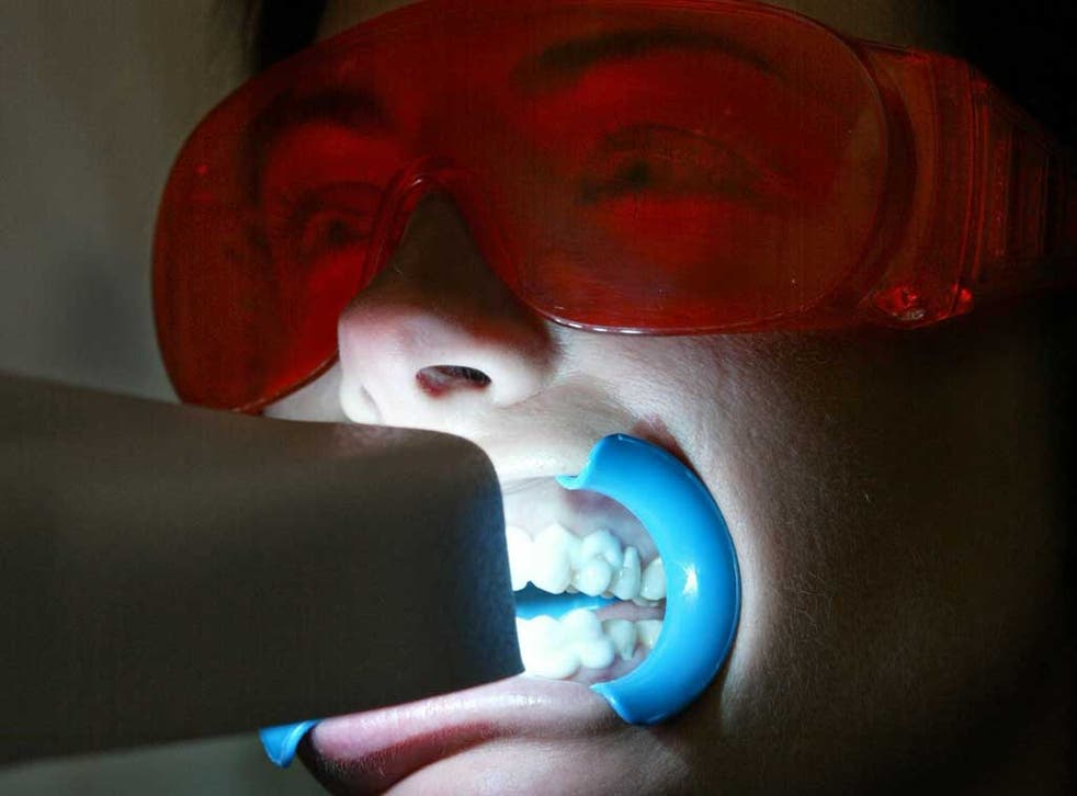 The safe way: A cosmetic dentist using UV to whiten teeth