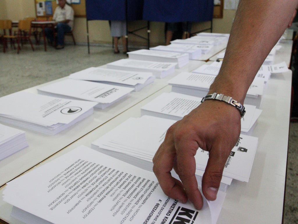 A man picks up a ballot in the northern port city of Thessaloniki