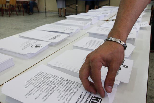 A man picks up a ballot in the northern port city of Thessaloniki