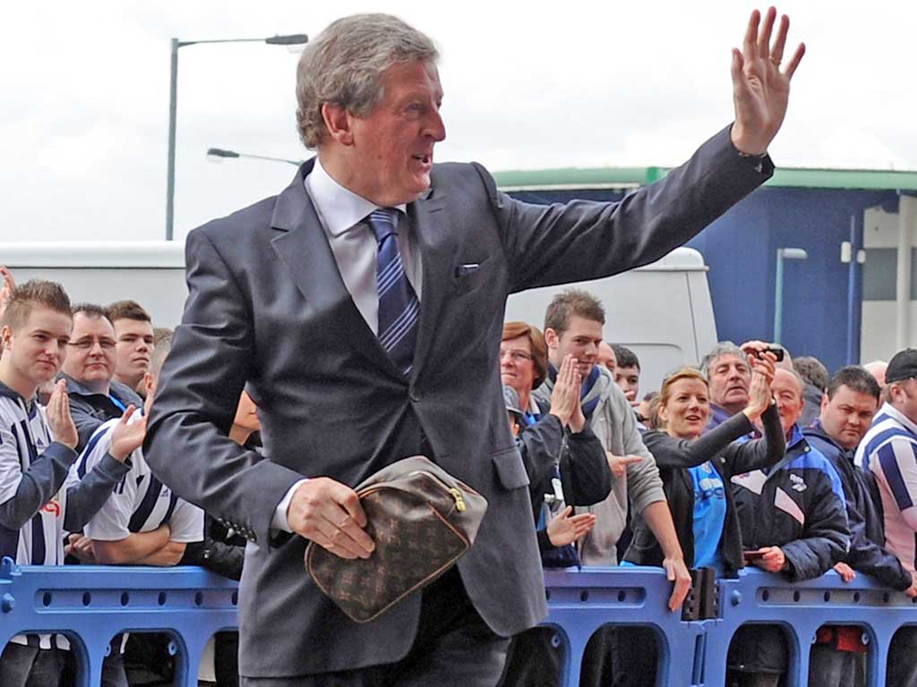 Roy Hodgson waves to fans as he arrives for the game between West Bromwich Albion and Bolton at the Reebok Stadium yesterday