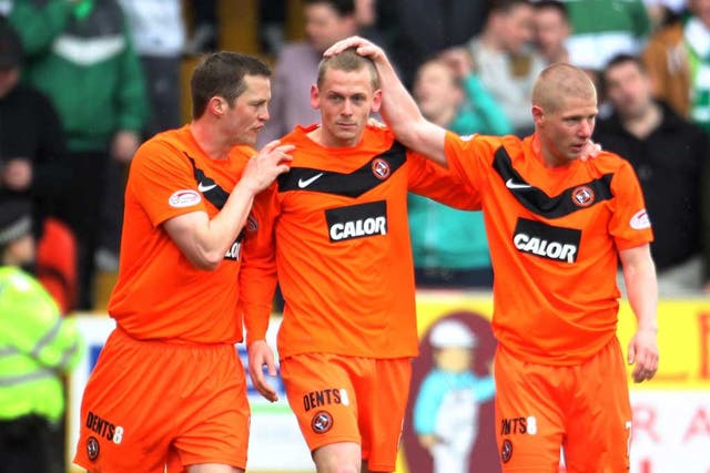 Dundee United’s Scott Robertson is congratulated on his winner