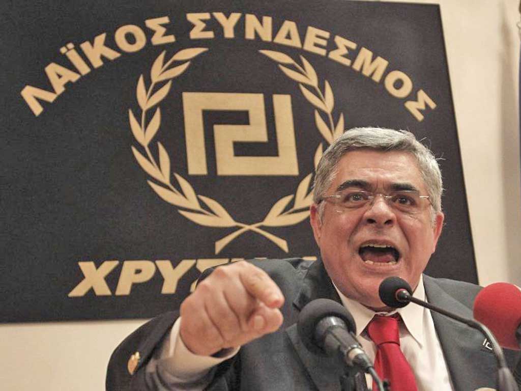 Leader of extreme-right Golden Dawn party Nikolaos Mihaloliakos talks at a news conference in Athens May