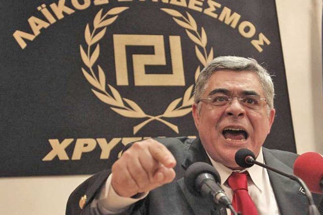 Leader of extreme-right Golden Dawn party Nikolaos Mihaloliakos talks at a news conference in Athens May