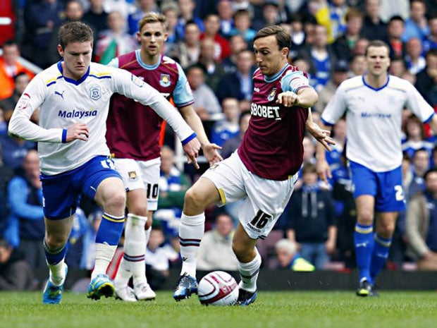 Cardiff City's Aron Gunnarsson (left) and West Ham United's Mark Noble battle for the ball during the npower Championship Playoff semi-final
