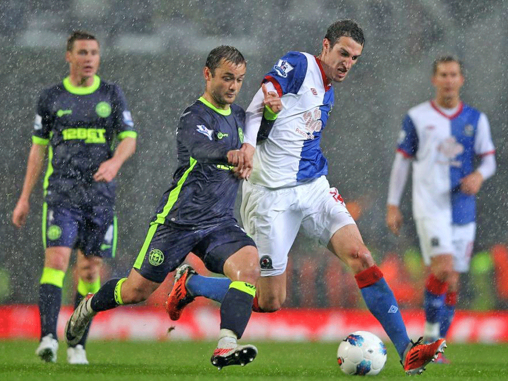 Shaun Maloney of Wigan Athletic competes with Radosav Petrovic of Blackburn Rovers during the Barclays Premier League match
