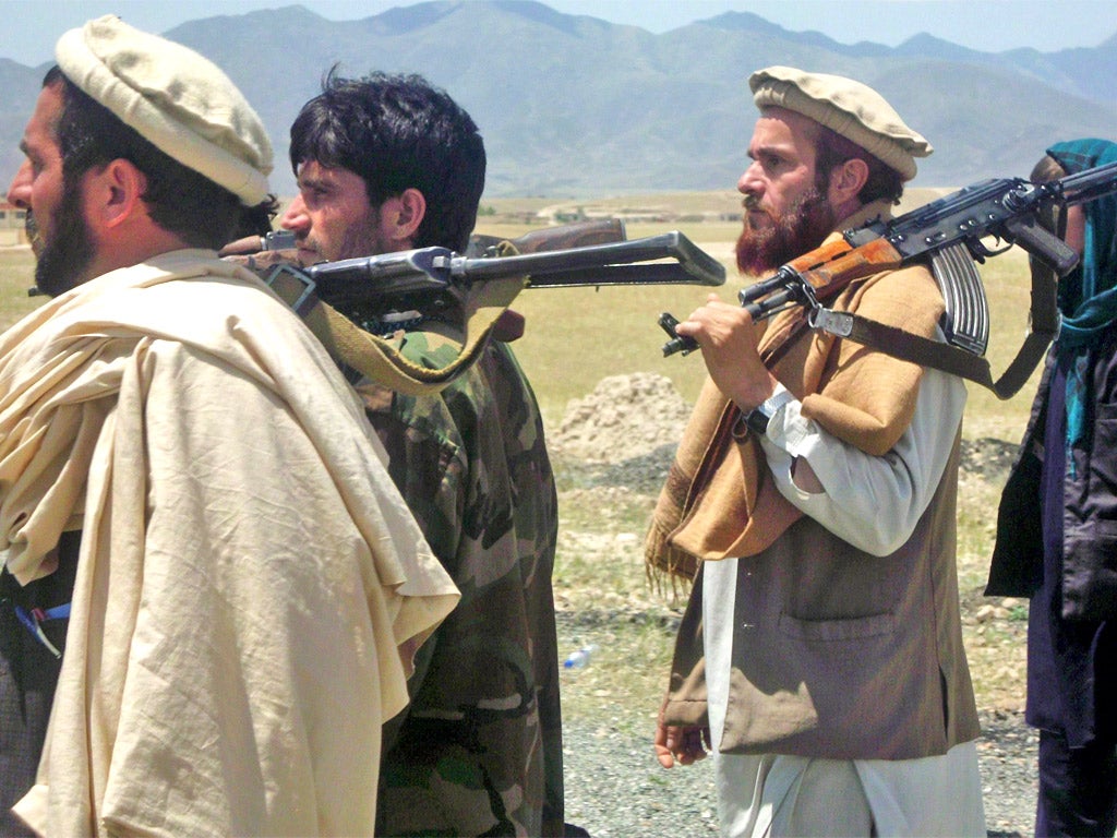 Images of Taliban fighters giving up their weapons appear to contradict claims of a growing insurgency