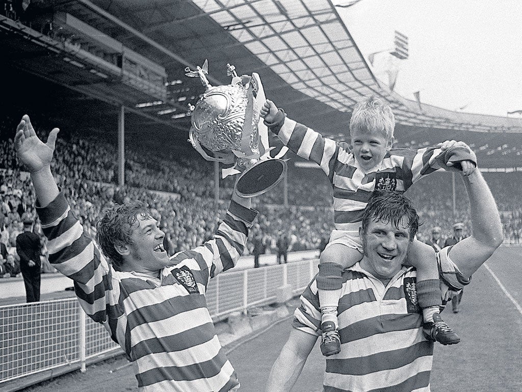Leigh’s Kevin Ashcroft (left) and his son - team mascot Gary - celebrate with Peter Smethurst