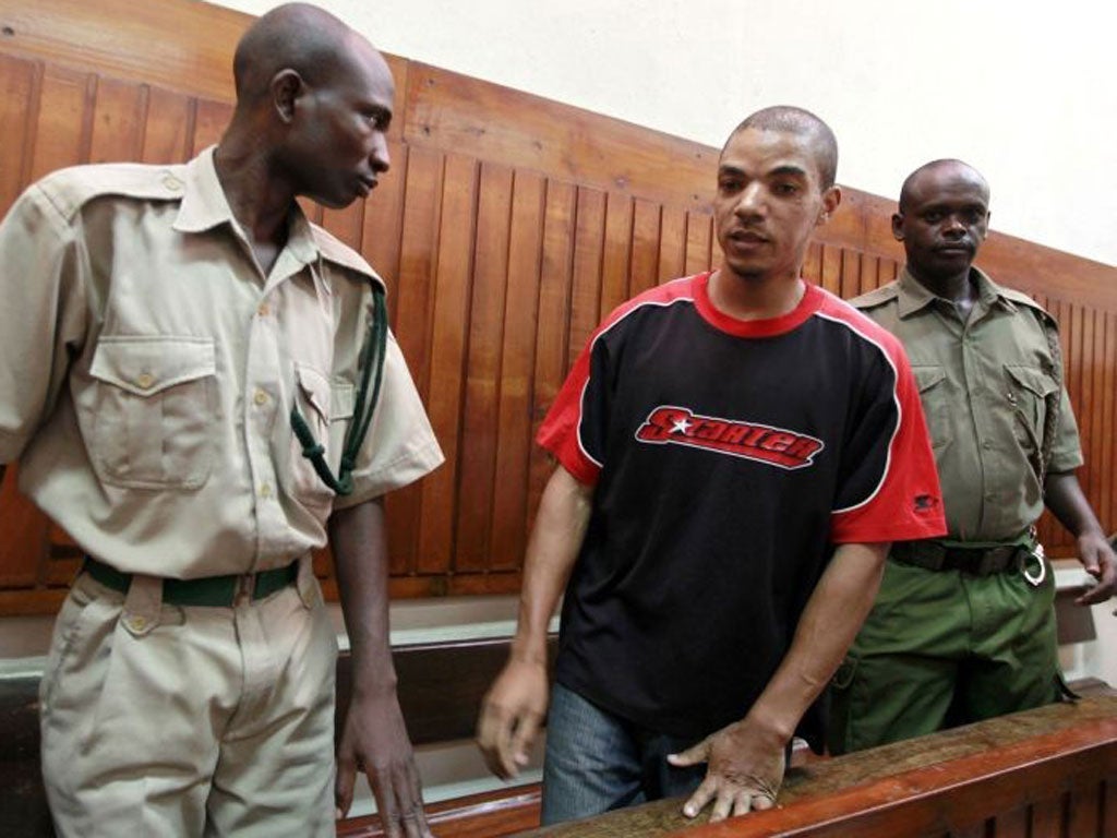 Jermaine Grant, centre, is escorted into court in the Kenyan coastal town of Mombasa